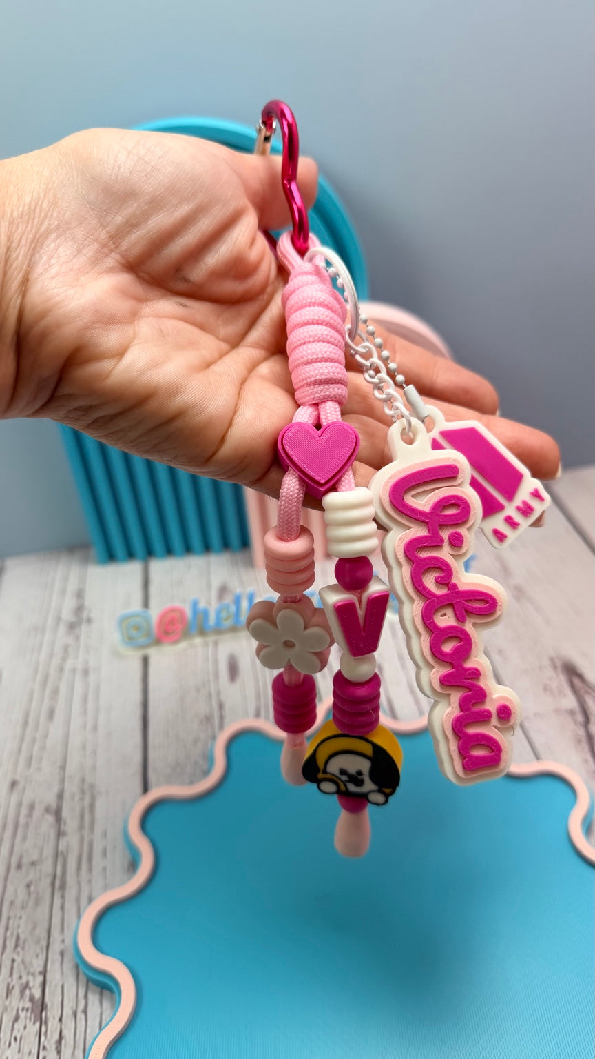 Close-up of pink personalized beaded wristlet keychain with custom name and charms